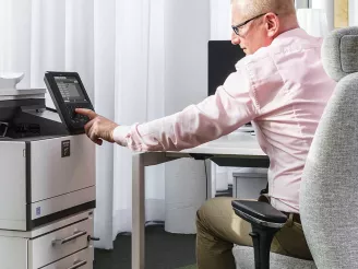 Man using all-in-one / multifunction printer
